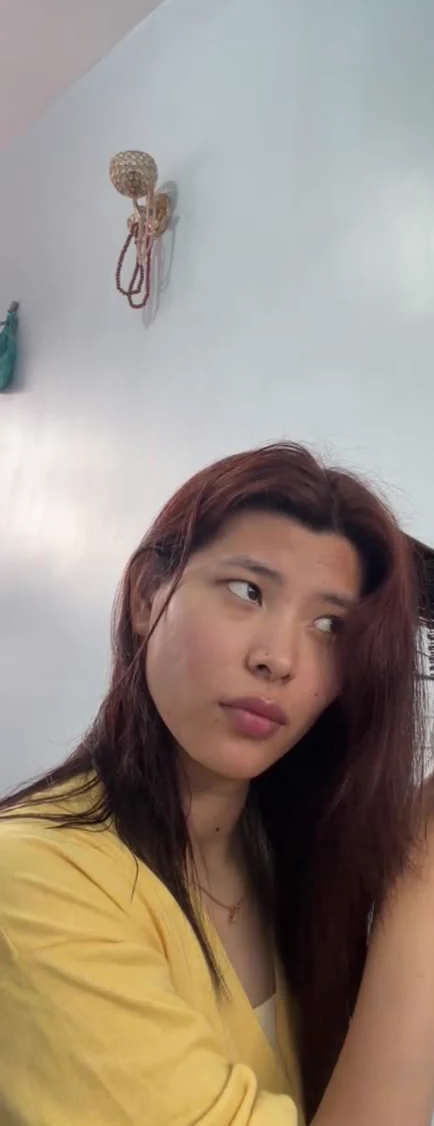 Sonam arranging her hair during a video call.