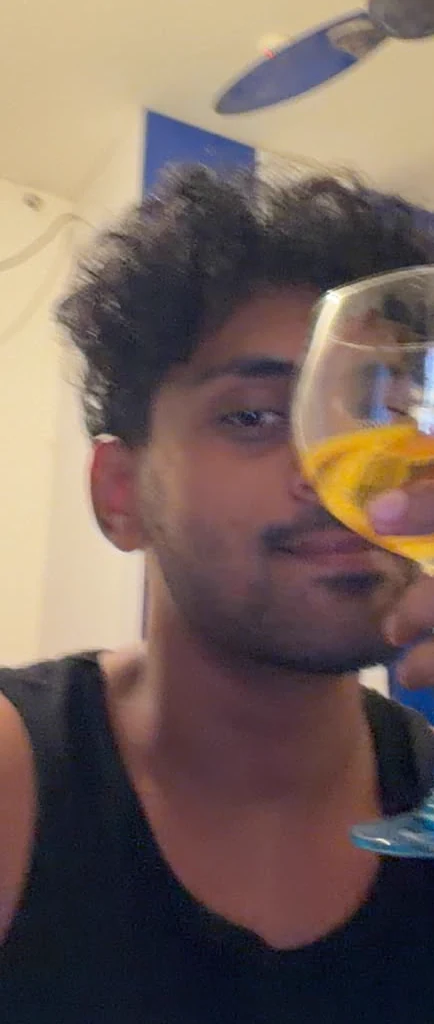 Saharsh raising a glass during a video call.