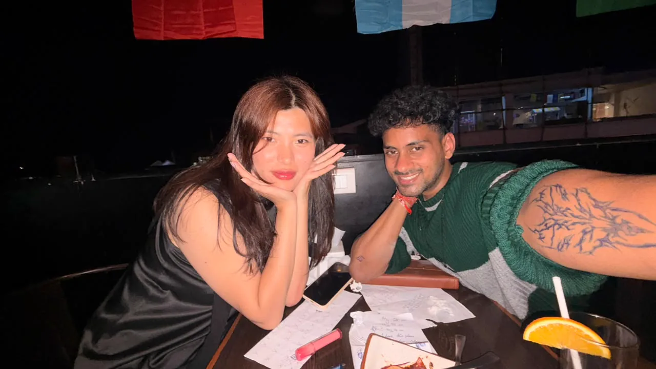 Saharsh and Sonam at the table with papers, drinks, and temporary drawings visible.
