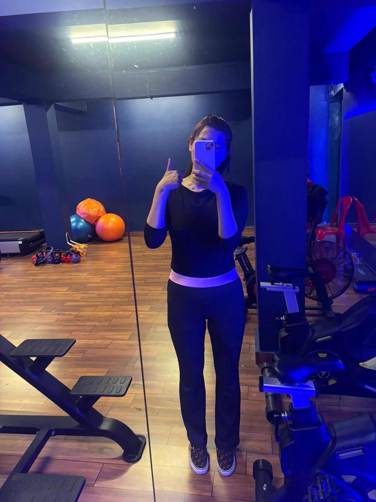 Sonam taking a mirror photograph inside a gym.